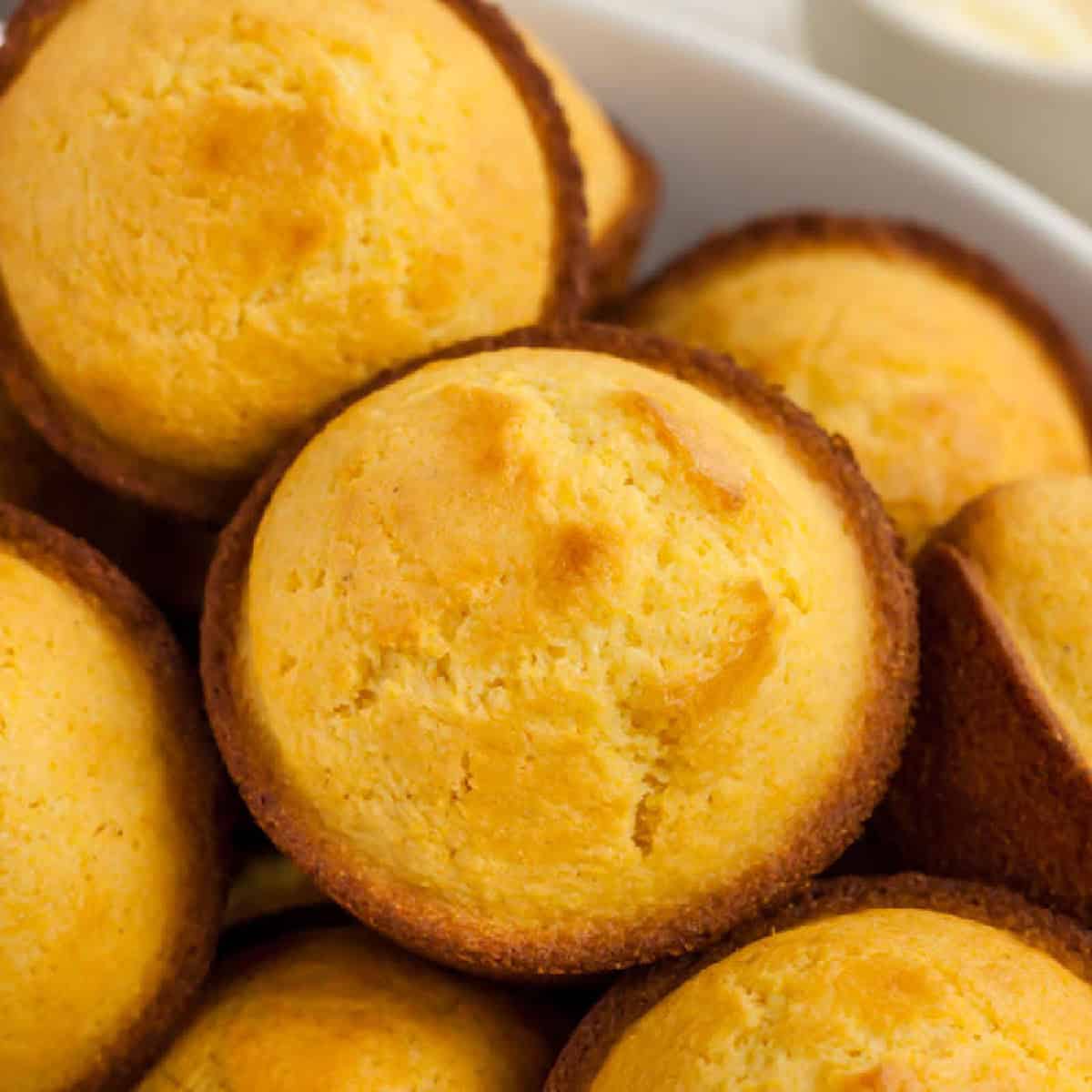 Cornbread Muffins are just so easy to make and much better than those store bought mixes. This cornbread muffin recipe is delicious and a family favorite. bowl of corn muffins