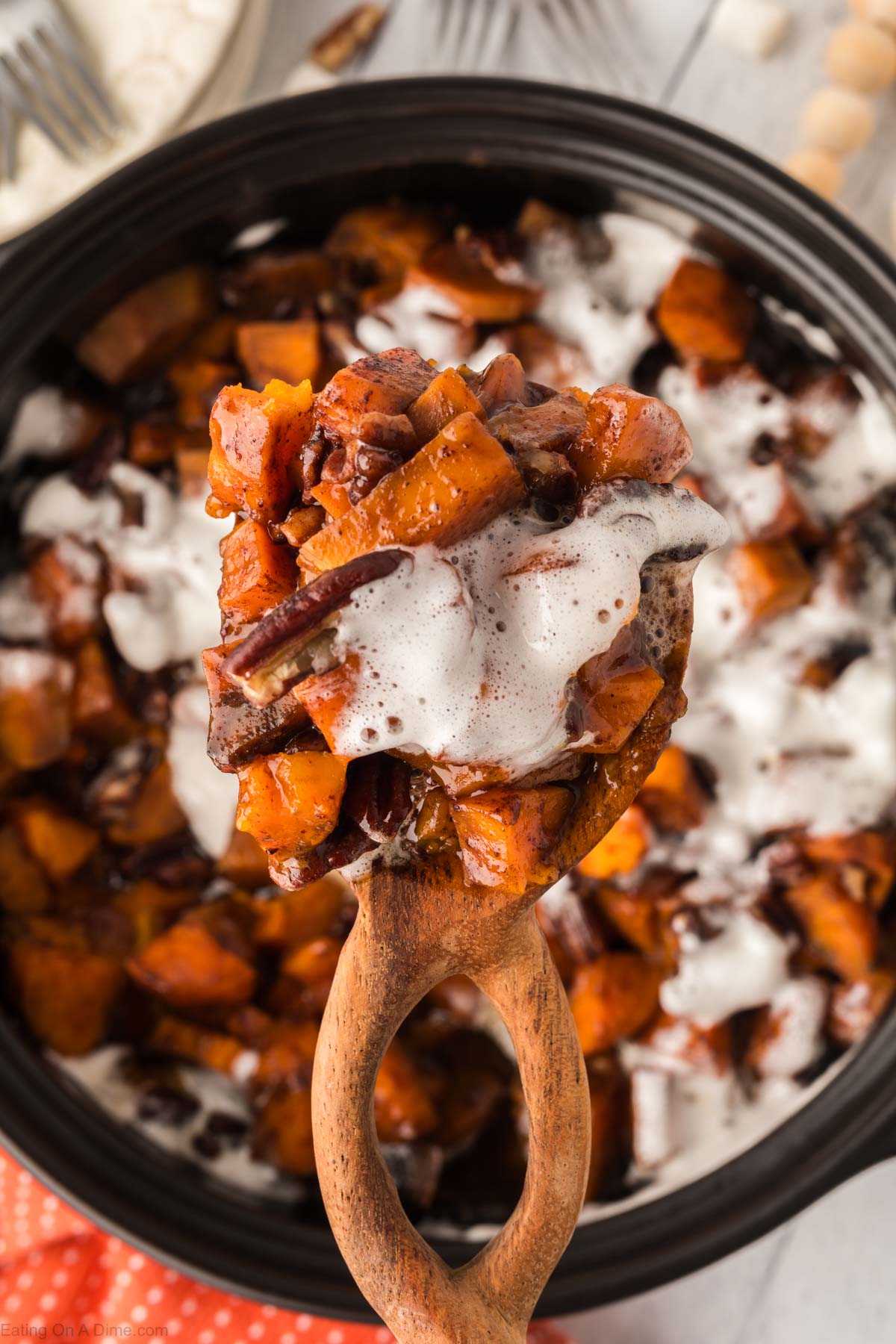 Dishing a serving with a wooden spoon from the slow cooker