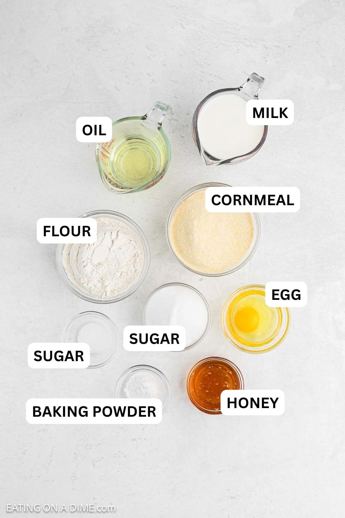 Ingredients needed to make this recipe includes flour, cornmeal, sugar, honey, salt, baking powder, egg, milk, and oil.