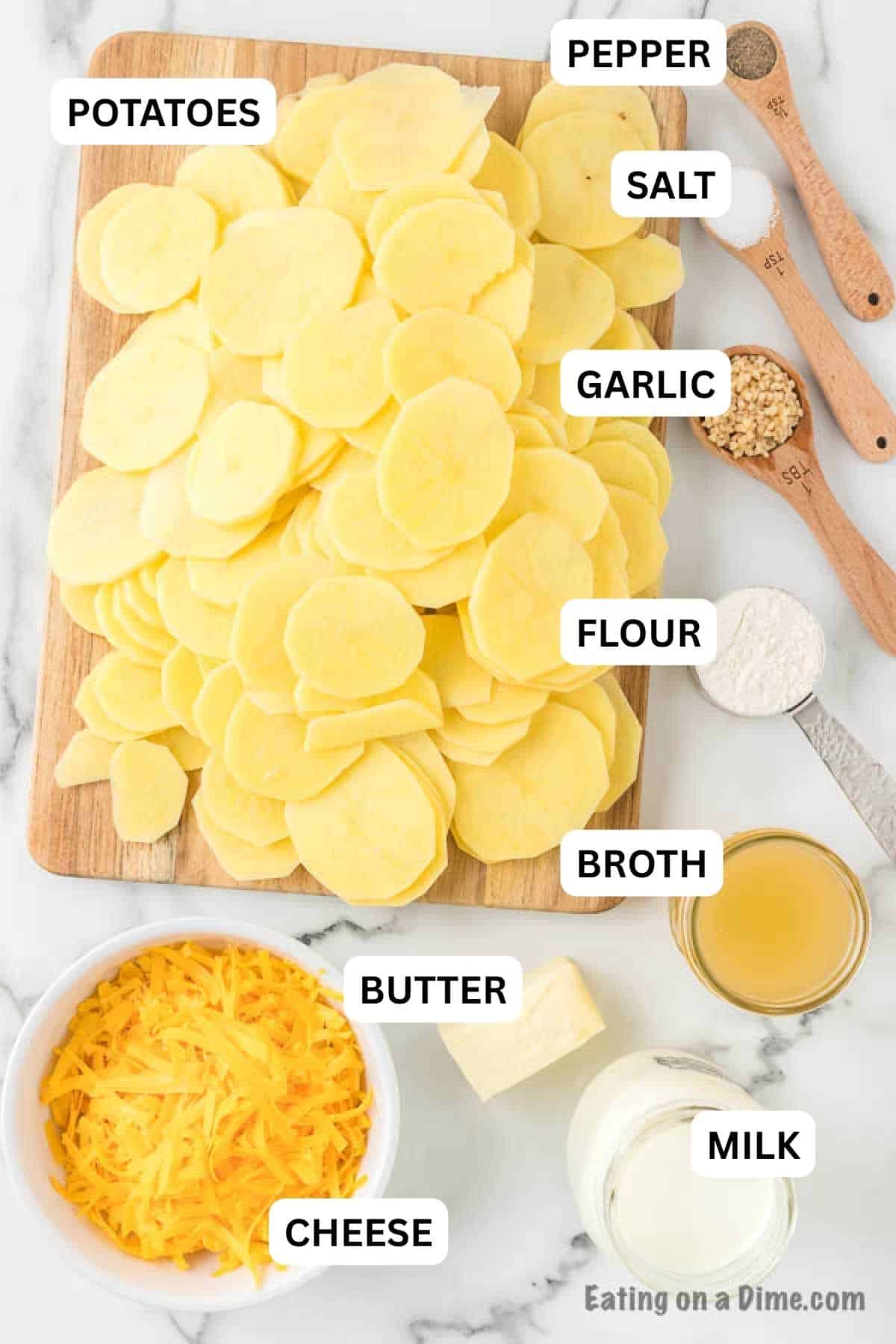 Ingredients needed to make this recipe which includes potatoes, butter, flour, milk, chicken broth, salt, pepper, minced garlic, and cheddar cheese.