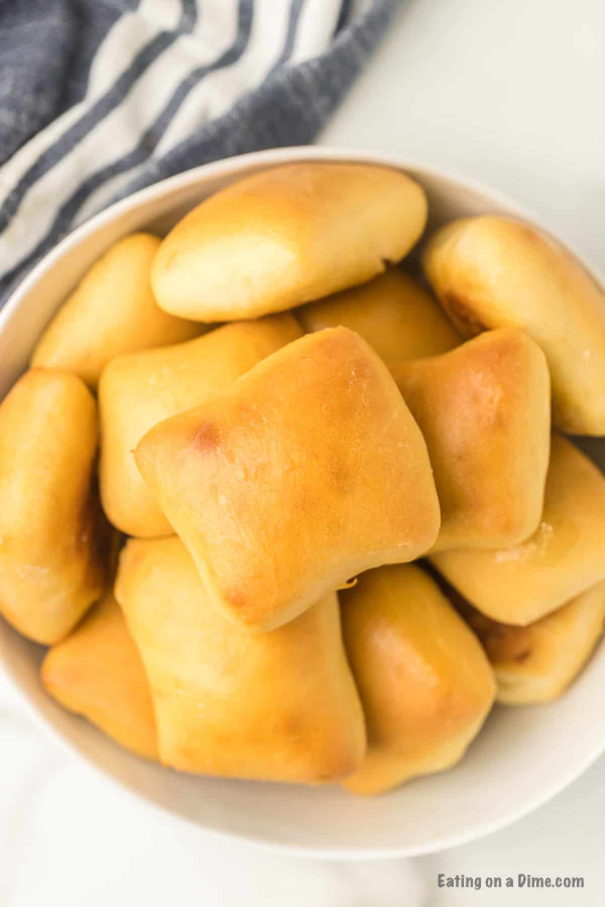 Serving bowl of rolls piled high.