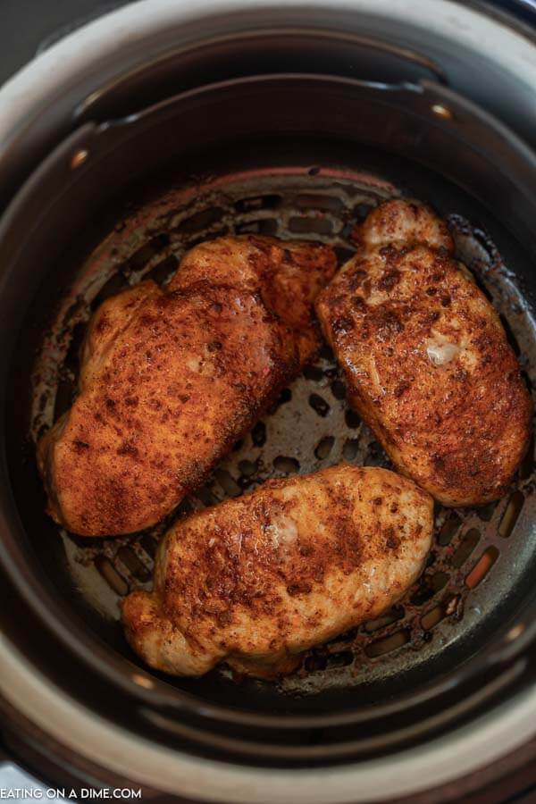 Close up image of pork chops in an air fryer. 