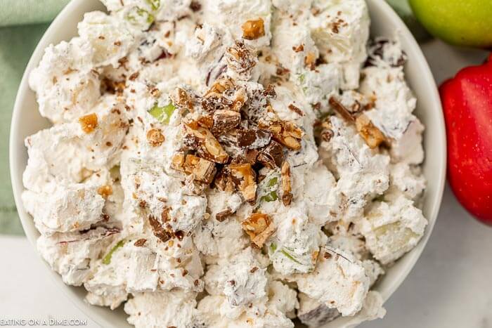 Close up image of snicker apple salad in a white bowl. 