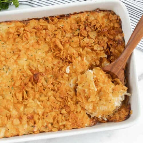 Close up image of a 9x13 casserole dish a cheesy chicken hashbrown casserole.