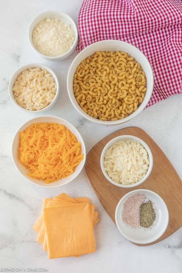 Ingredients needed for mac and cheese - elbow macaroni, water, milk, salt and pepper, american cheese, cheddar cheese, bellavitano cheese, romano cheese, parmesan cheese. 