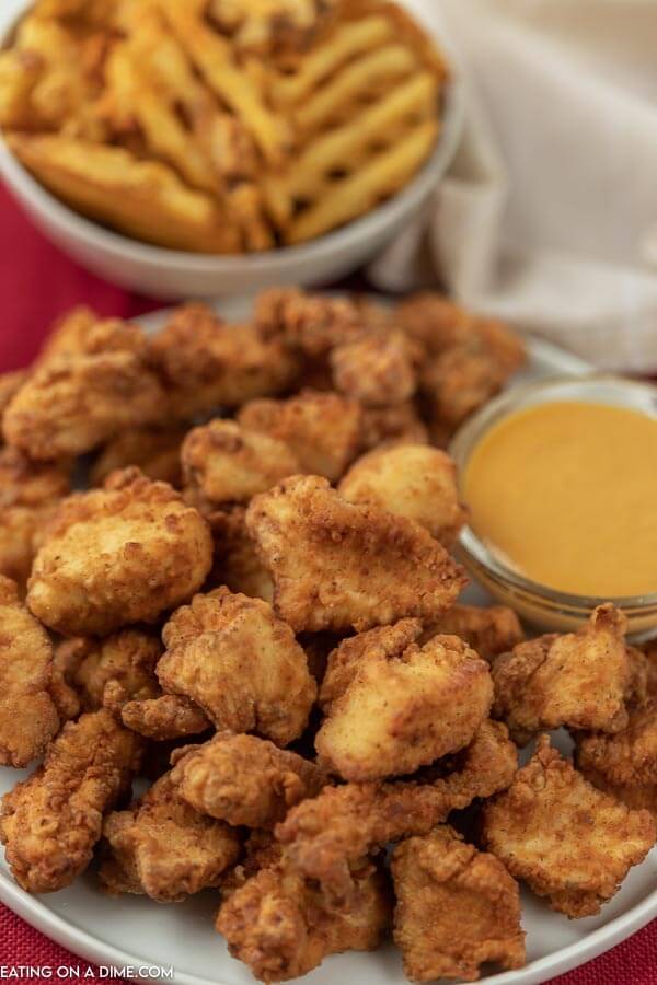 Plate of copycat chick fil a nuggets with honey mustard. 