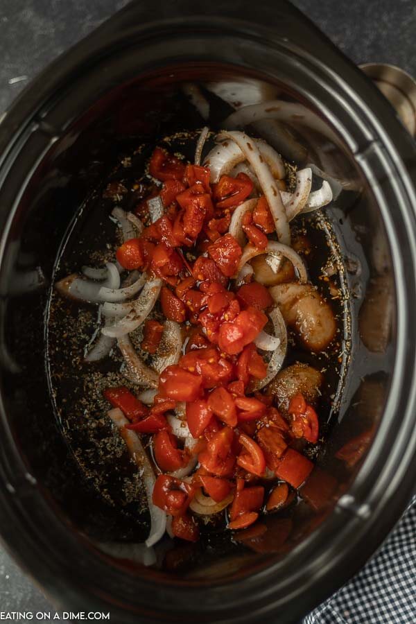 Close up image of balsamic chicken just being put in the crock pot with all the ingredients. 