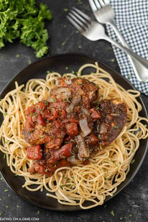 Close up image of balsamic chicken on pasta. 