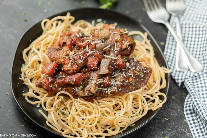 Close up image of balsamic chicken on pasta. 