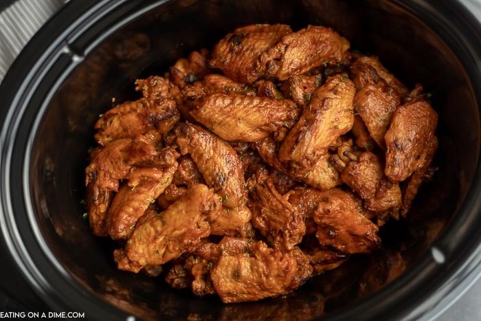 Crock pot of cooked chicken wings.