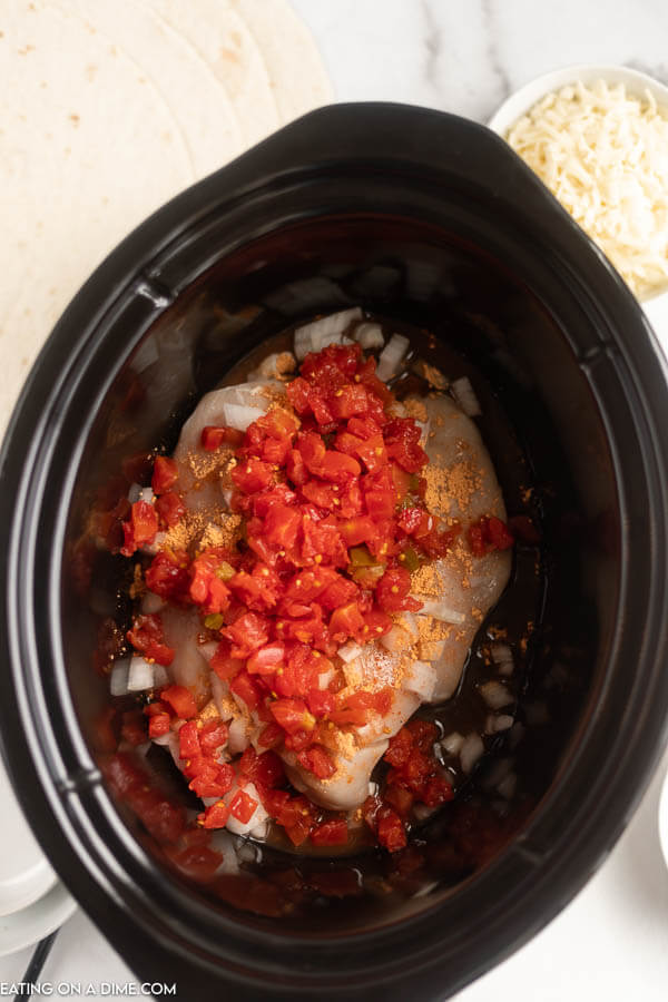 Close up image of chicken with ingredients prior to being cooked. 