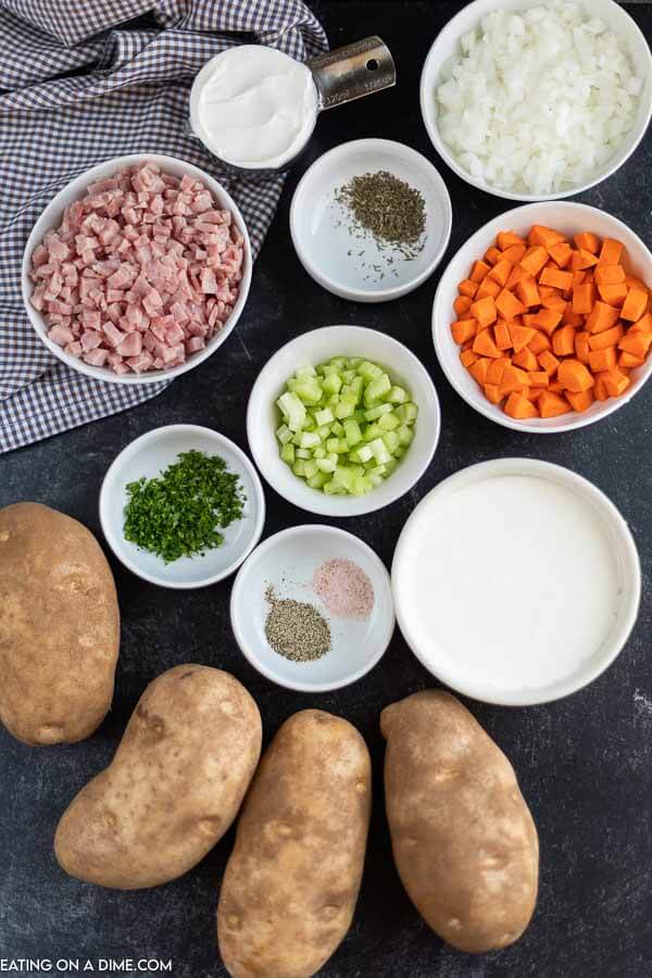 Ingredients for soup: potatoes, onion, carrots, seasoning, vegetables. 