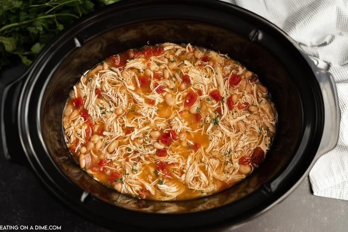 Try Crockpot Chicken Taco Soup when you need a tasty dinner fast. Simply toss all the ingredients in the slow cooker and Taco Chicken Soup will be ready! Close up image of crock pot chicken taco soup.