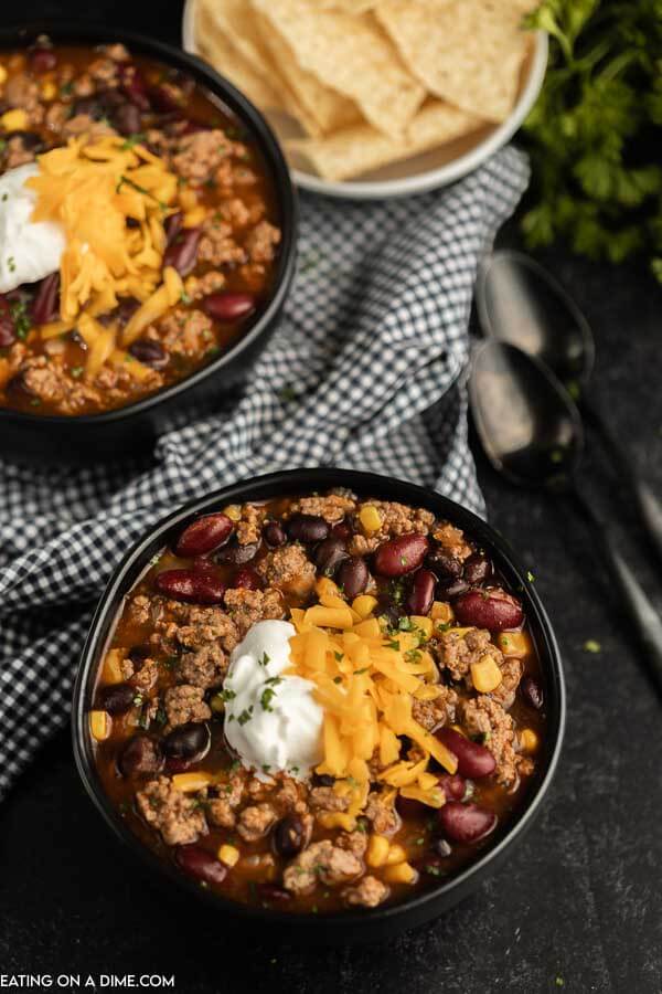 Close up image of two black bowls of taco soup. 