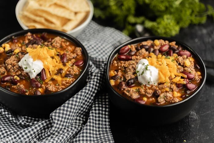 Close up image of two black bowls of taco soup. 