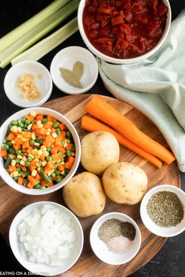 Ingredients needed for Vegetable Soup - onion, celery, carrots, gold potatoes, fire roasted tomatoes, frozen vegetables, bay leaves, dried thyme, minced garlic, salt and pepper, italian seasoning vegetable stock