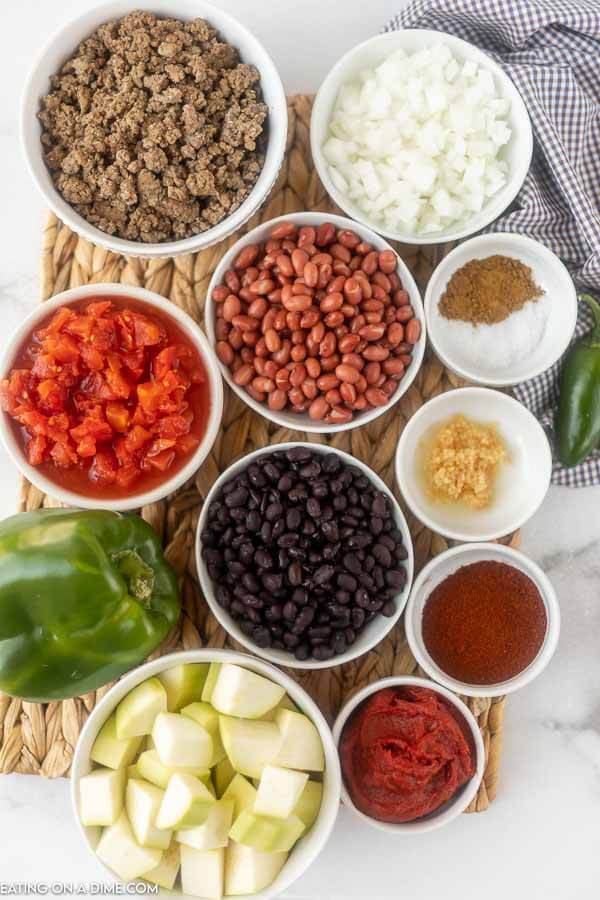 Ingredients needed for vegetable and beef chili - beef, zucchini, onion, green bell pepper, jalapeno, diced tomatoes, tomato paste, kidney beans, black beans, minced garlic, chili powder and cumin, salt and water. 