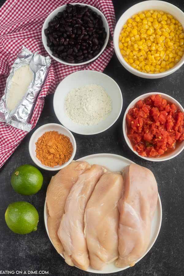 Ingredients needed for Fiesta Chicken - chicken breast, ranch seasoning mix, chicken broth, taco seasoning, black beans, rotel, corn, cream cheese, limes
