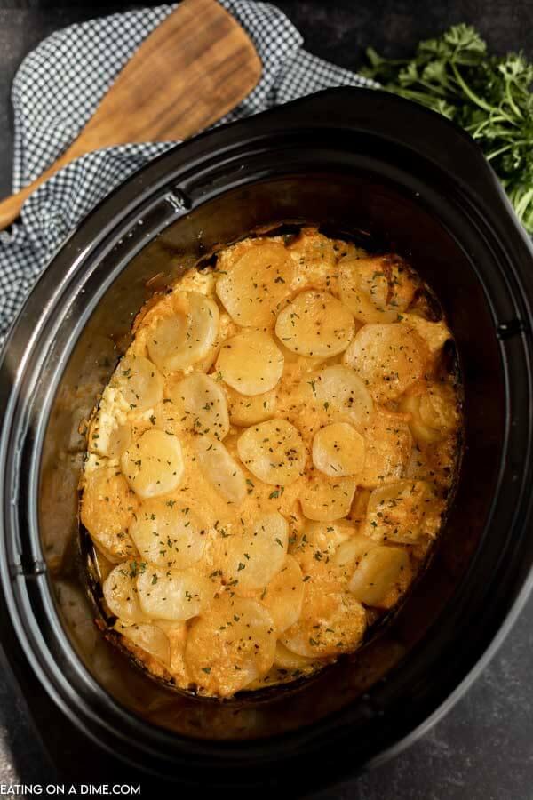 Close up image of scalloped potatoes in a crock pot. 
