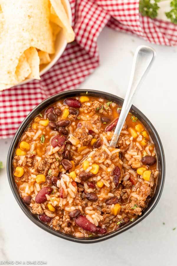 Bowl of Crockpot Taco Rice Soup with a spoon.