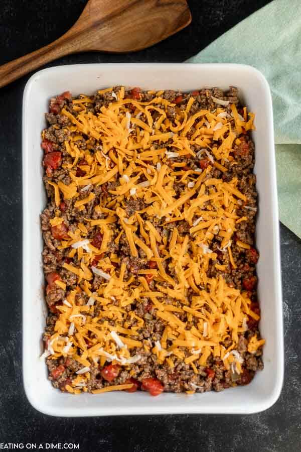 Close up image of the beef mixture topped with cheese in the casserole dish. 