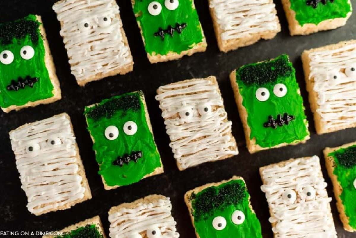 Looking for a cute hallowee treat idea? You are going to love these easy Halloween Rice Krispie Treats. Deorate them in 10 minutes! Halloween Rice Krispie Treats decorated like monsters and mummys.