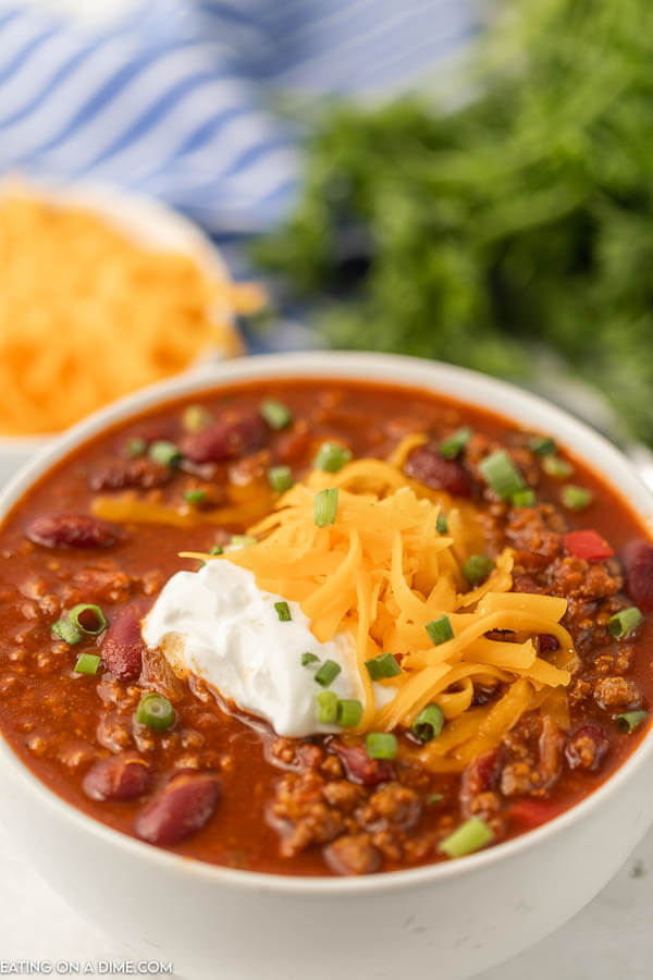 Bowl of cowboy chili topped with sour cream and cheese. 