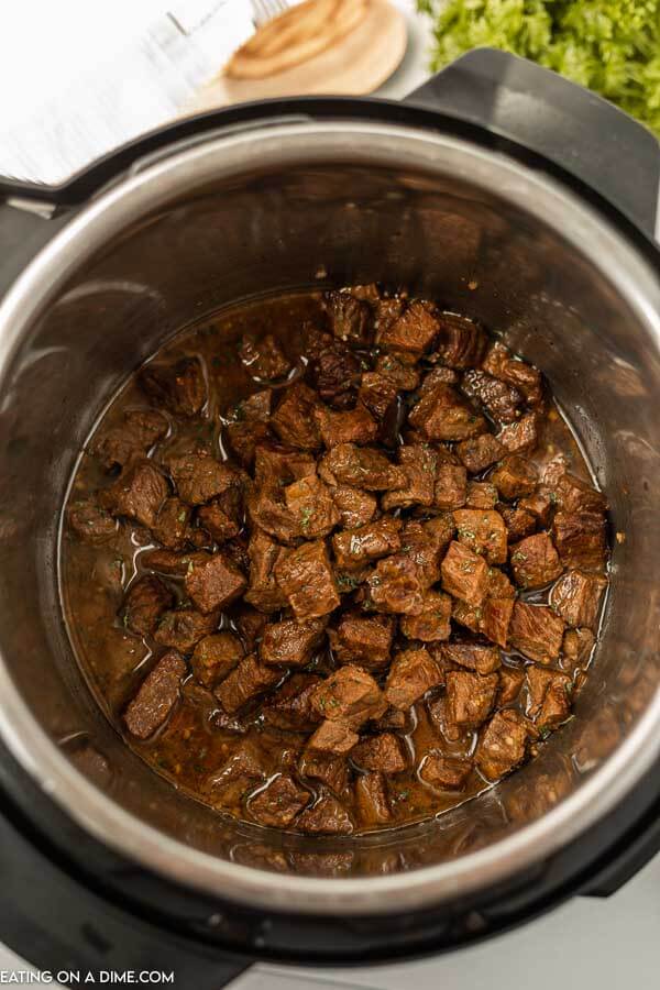 close up image of steak bites finished cooking in the instant pot. 