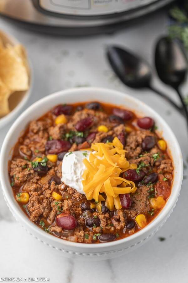 Bowl of taco soup with sour cream and cheese. 