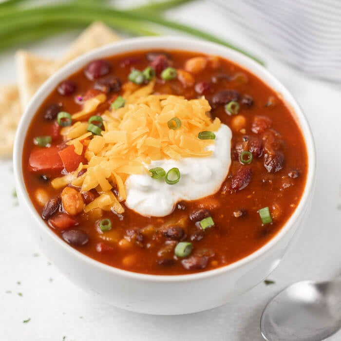 Close up image of vegetarian chili in a white bowl. 