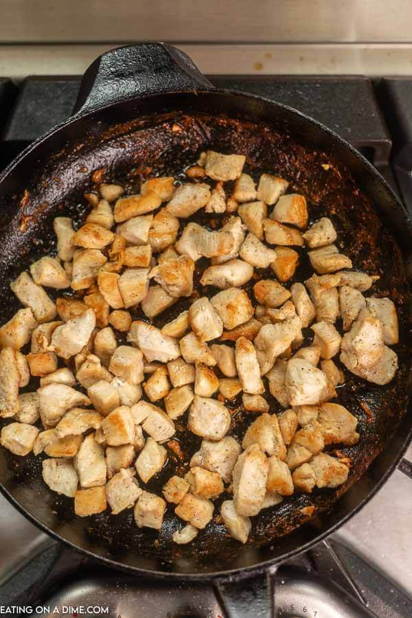 Chicken cooking in skillet. 