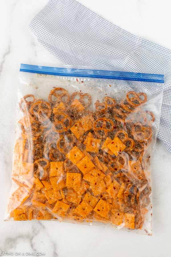 Close up image of snack mix in process in a zip lock bag. 