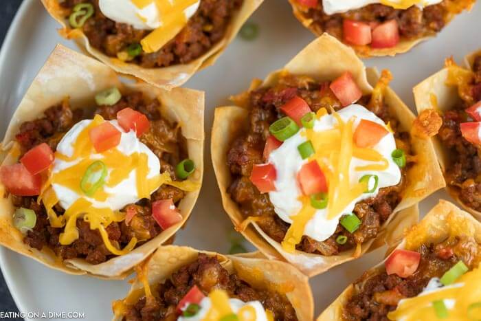 You will love these easy Wonton Taco Cups. This recipe has lots of cheese and yummy taco meat, veggies and more! Give it a try.