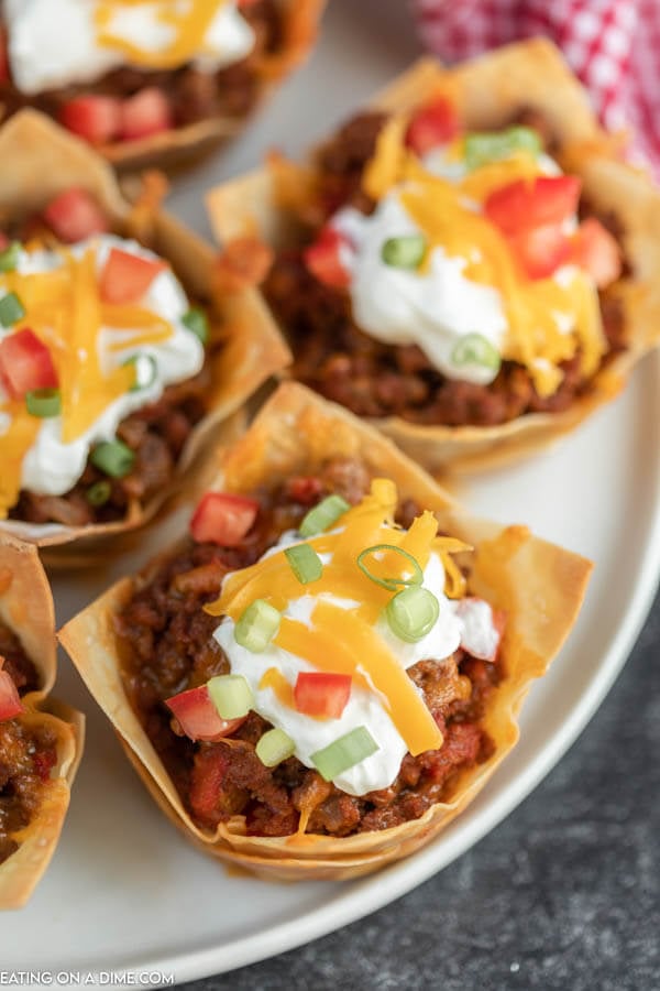 You will love these easy Wonton Taco Cups. This recipe has lots of cheese and yummy taco meat, veggies and more! Give it a try.