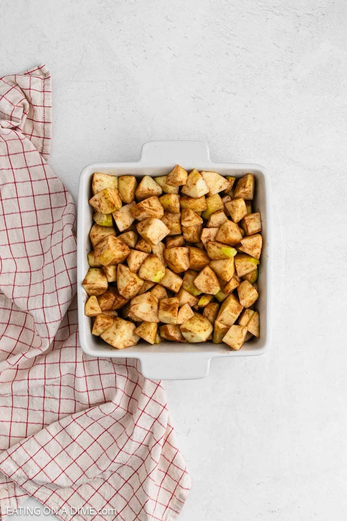 Cinnamon and sugar coated apples in a baking dish. 