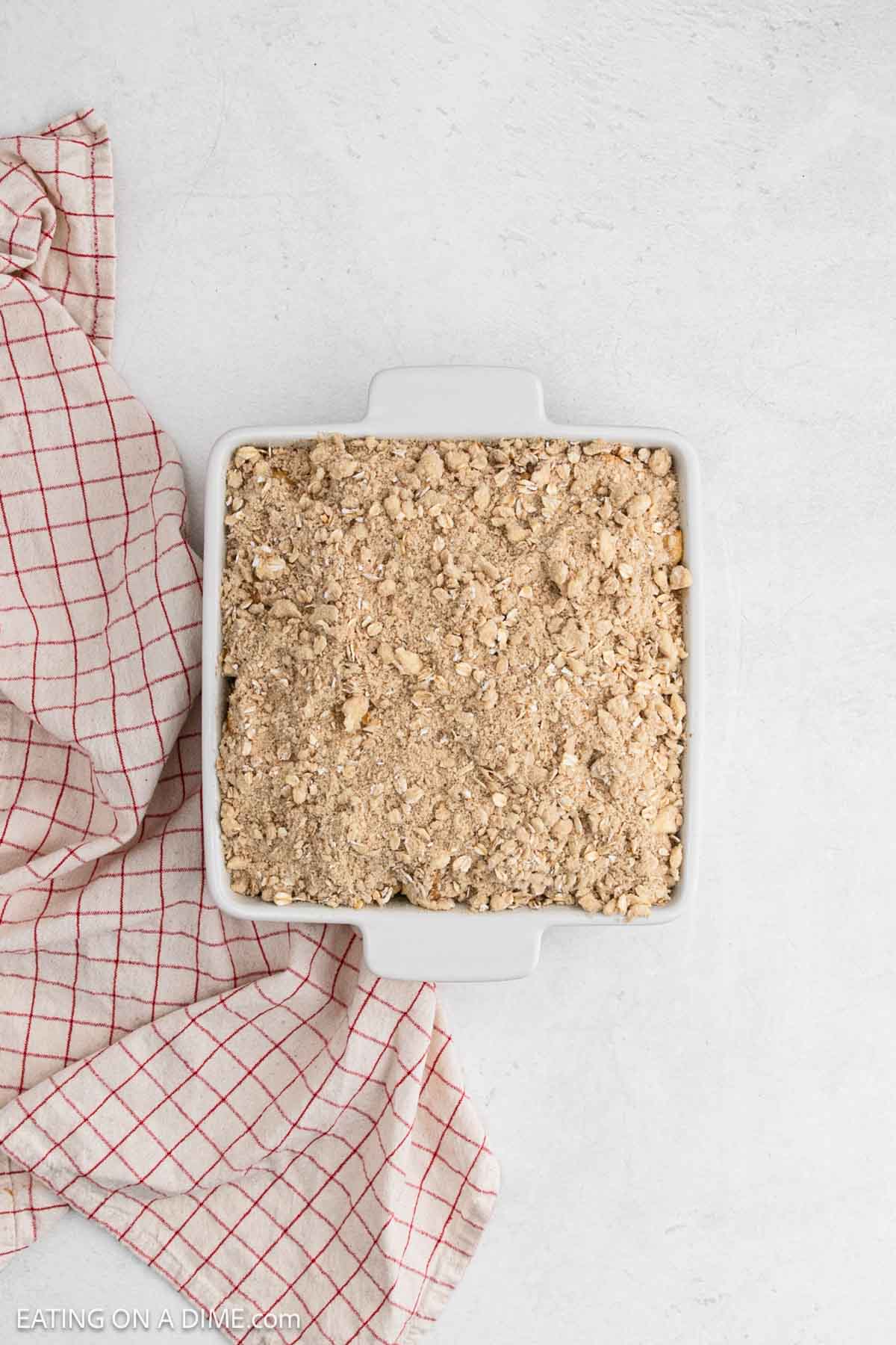 Crumble topping added to the baking dish. 