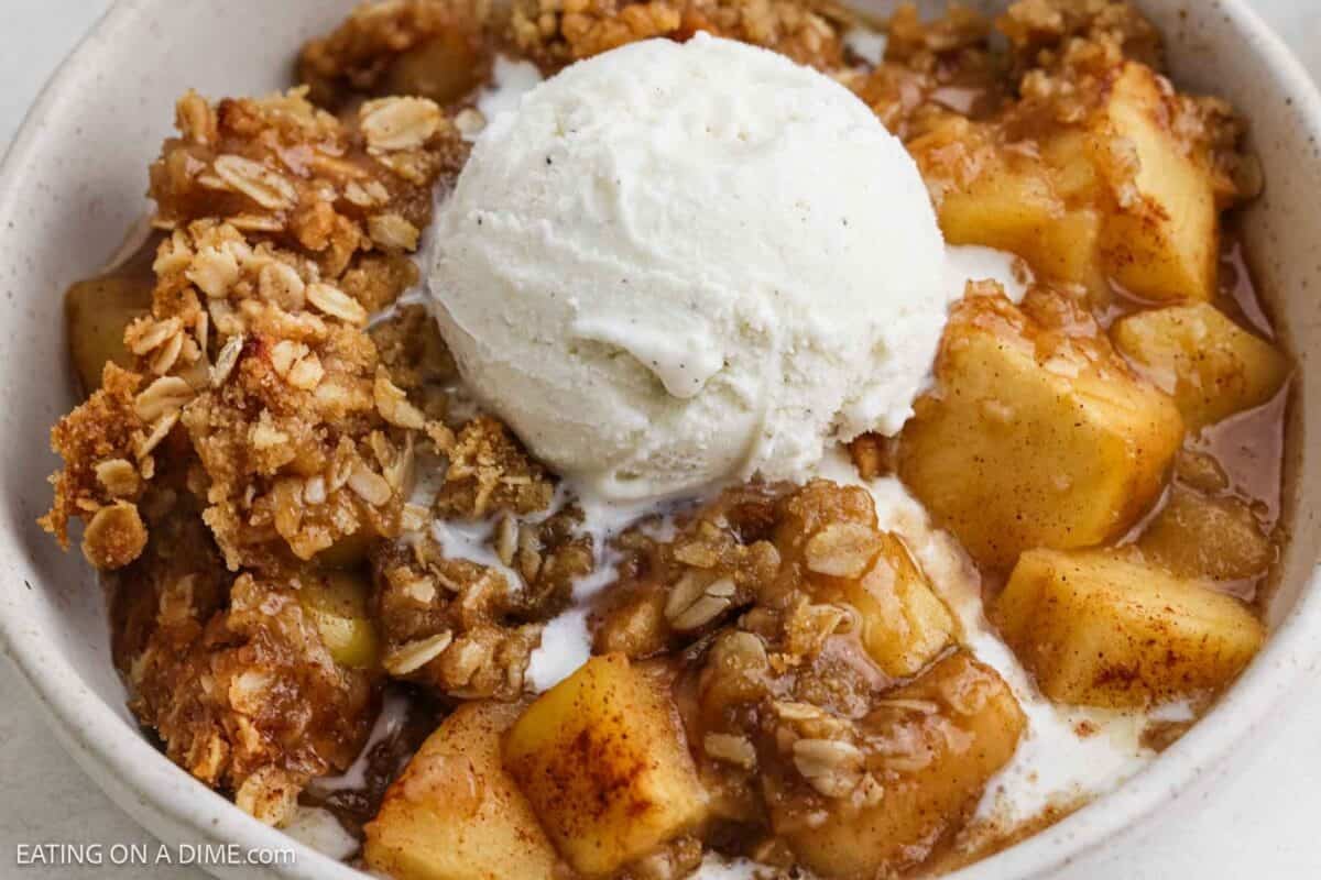 Apple Crisp Recipe topped with ice cream in a bowl. 