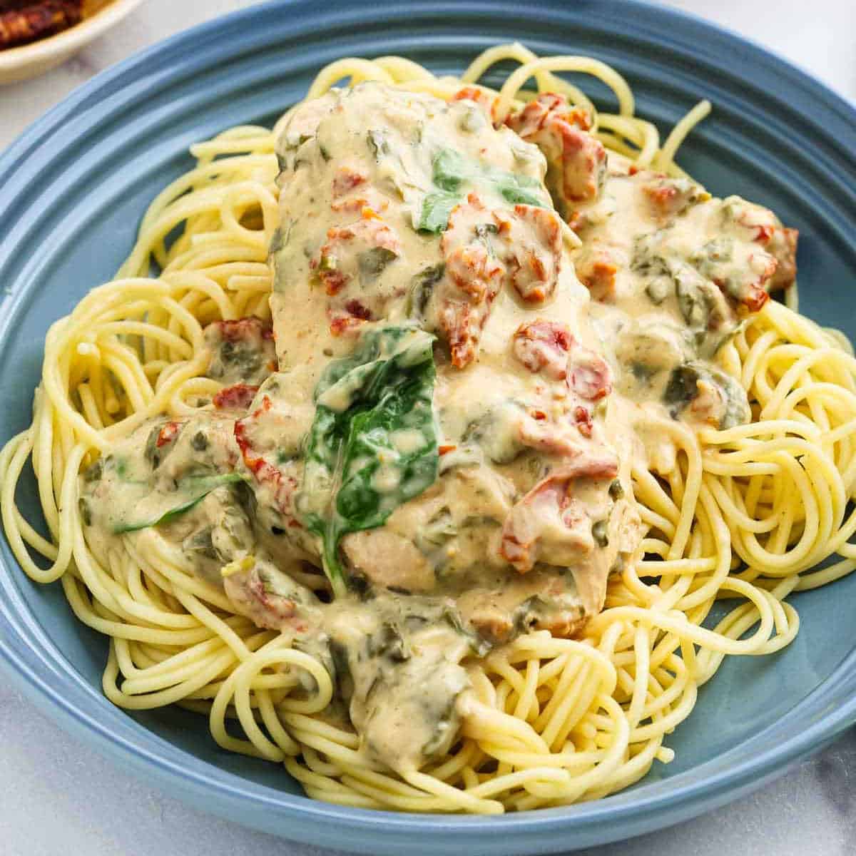 Chicken parmesan in creamy spinach sauce.