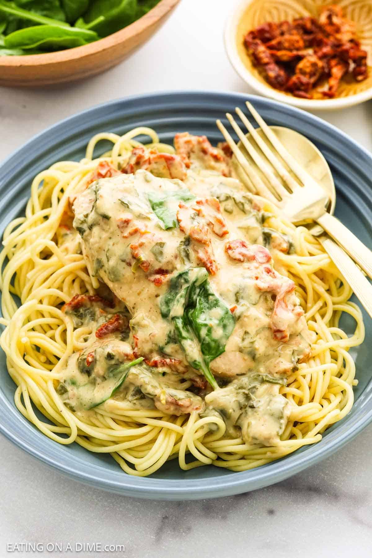 Tuscan Chicken on a plate with pasta