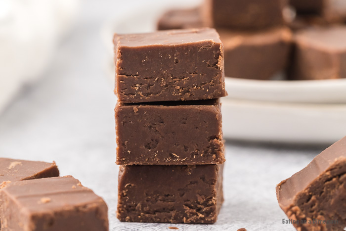 Close up image of chocolate peanut butter fudge stacked. 