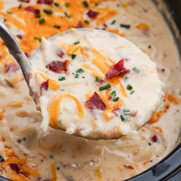 Crack Potato Soup in a crockpot with a serving on a ladle.