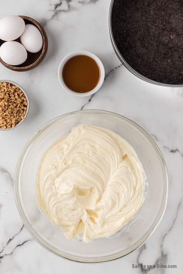 Beating the cream cheese, vanilla and sugar in a bowl