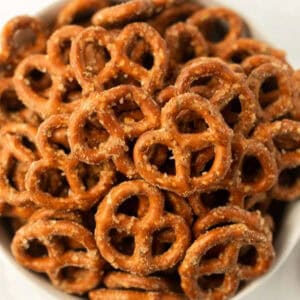 A close-up of a bowl filled with small, salted pretzels, showing their golden-brown, crunchy texture and coarse salt sprinkled on top—perfect for trying your favorite garlic ranch pretzels recipe.
