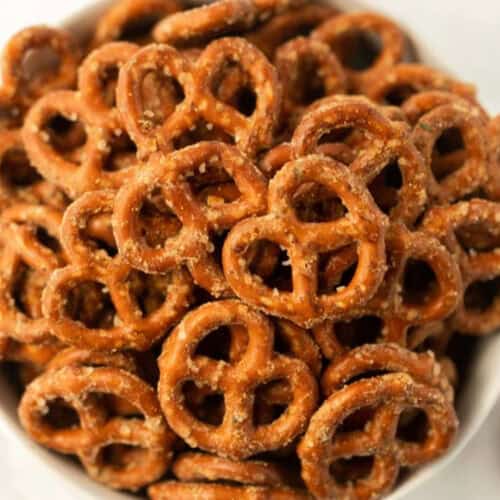 A close-up of a bowl filled with small, salted pretzels, showing their golden-brown, crunchy texture and coarse salt sprinkled on top—perfect for trying your favorite garlic ranch pretzels recipe.