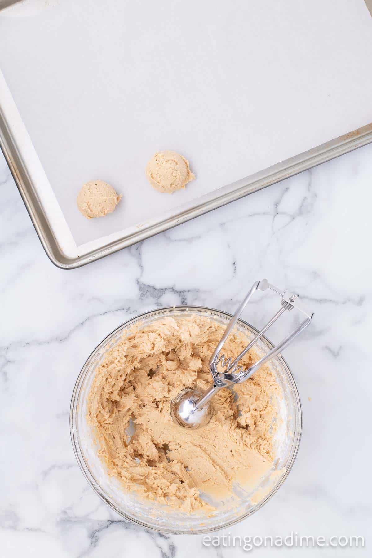 Scoop the dough onto baking sheet with cookie scoop