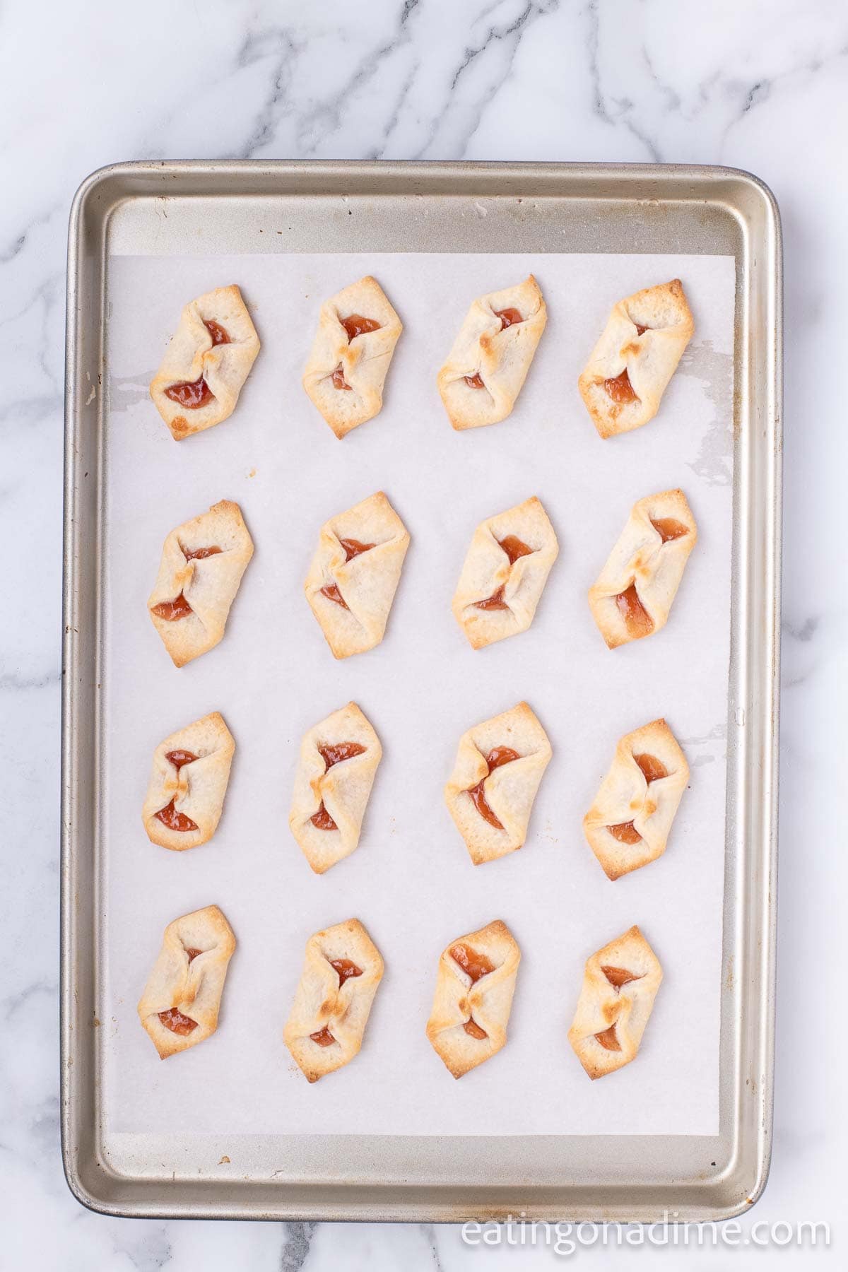 Baked Strawberry Pinch Cookies on a baking sheet