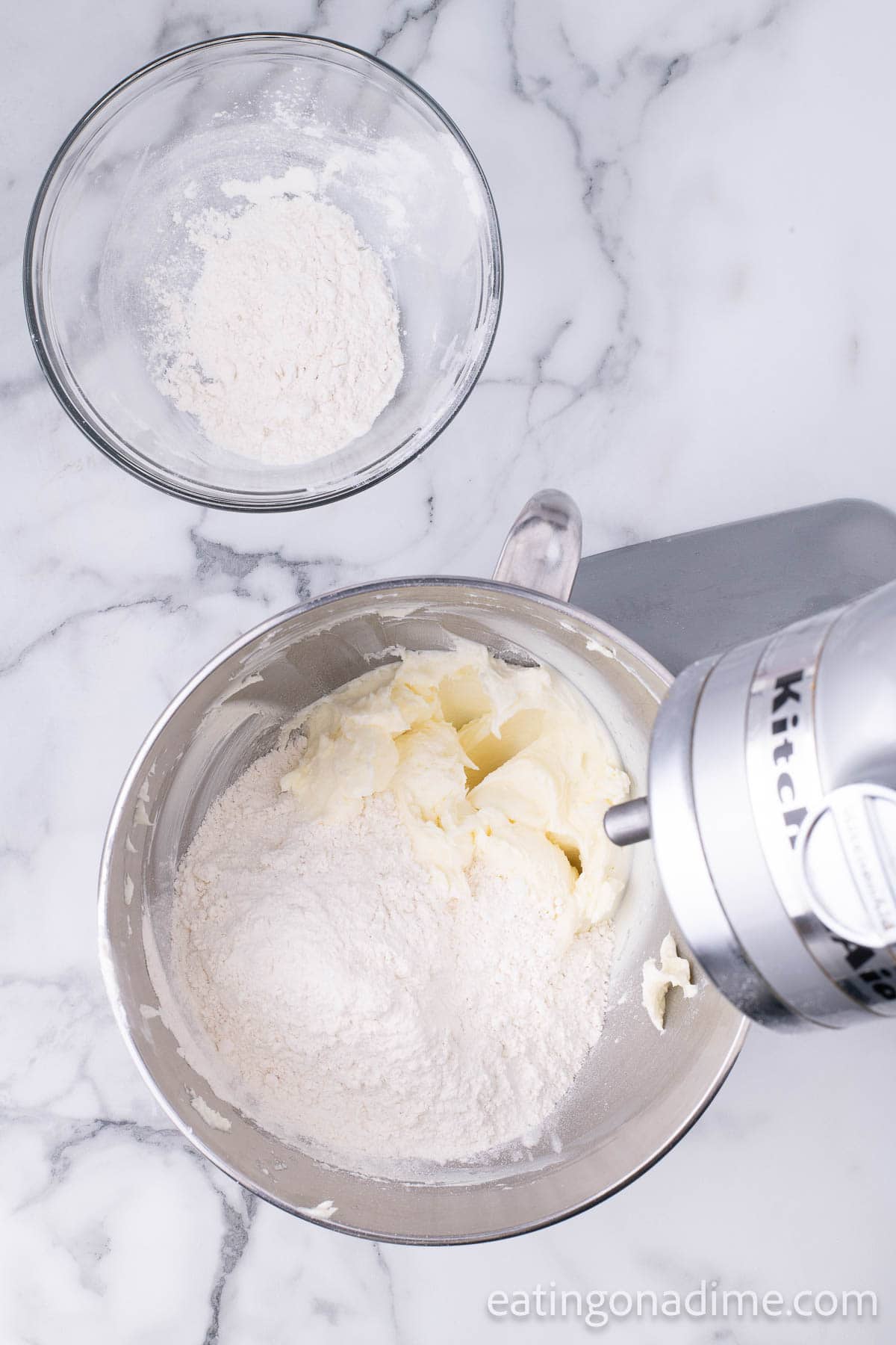 Adding the flour to the butter mixture in a stand mixer bowl
