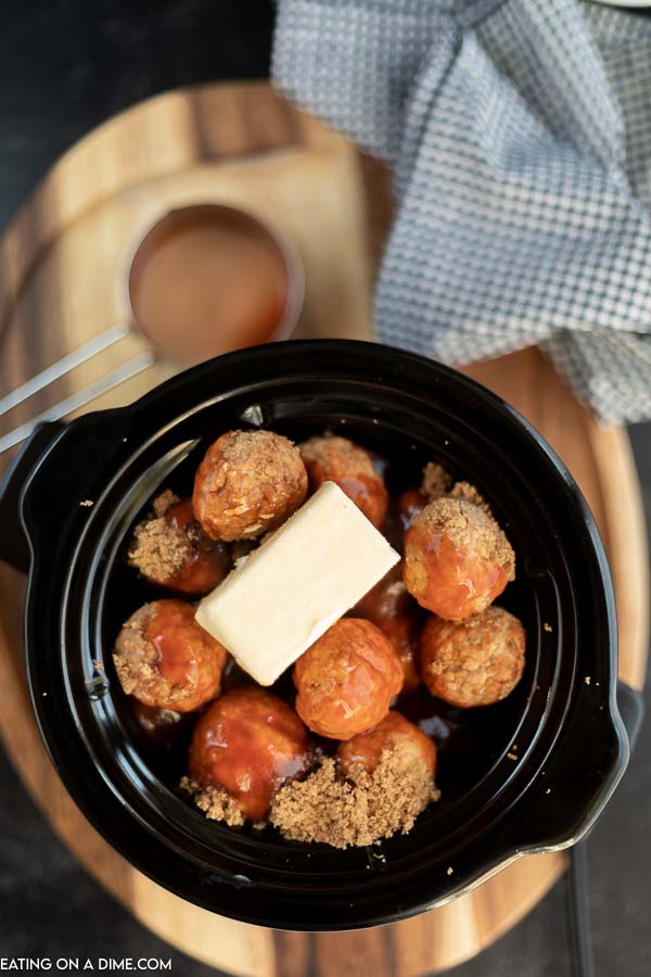 Close up image of meatballs in the crockpot uncooked. 