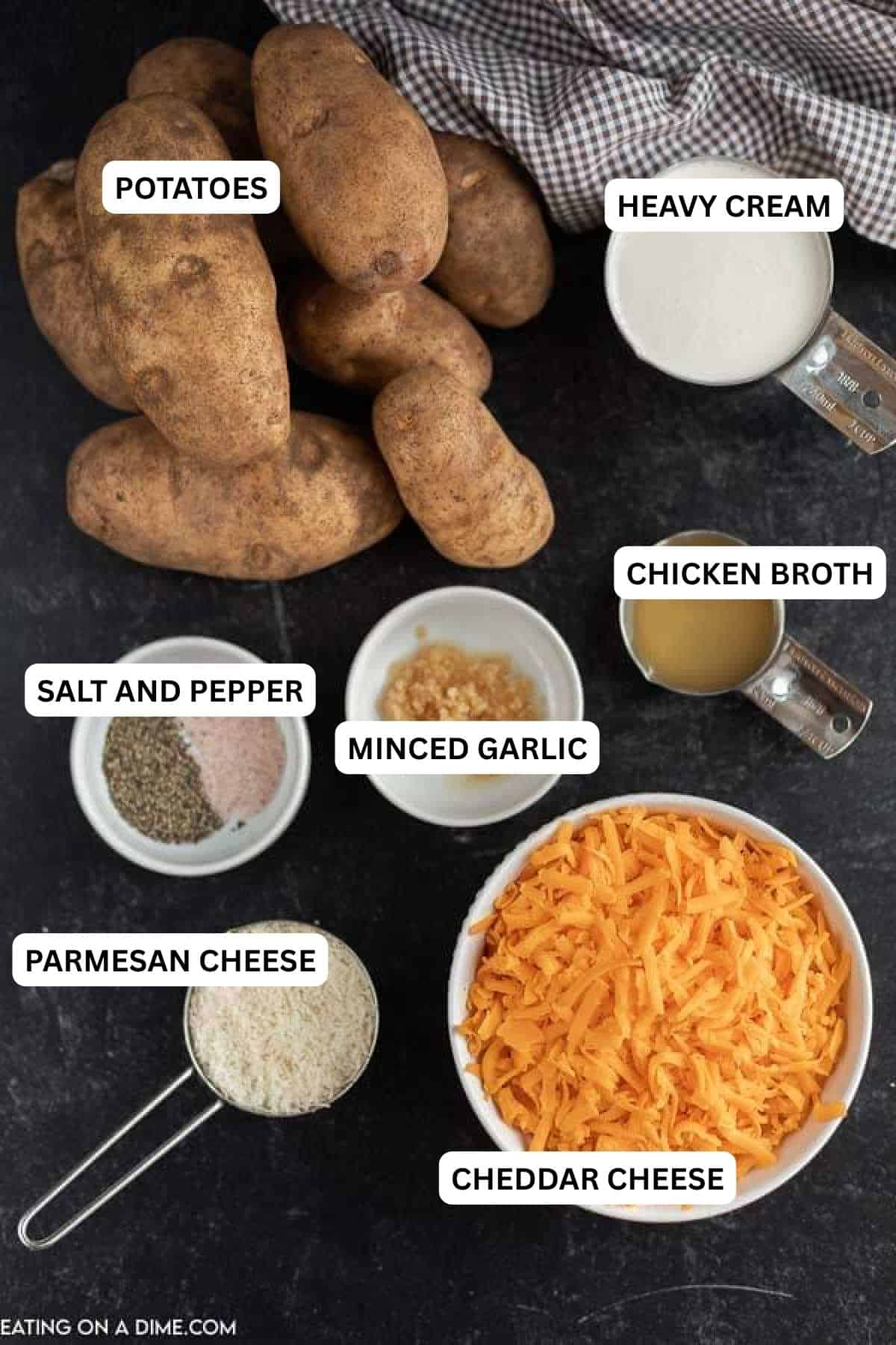 Ingredients for recipe - potatoes, heavy cream, salt and pepper, minced garlic, chicken broth, parmesan cheese and cheddar cheese. 