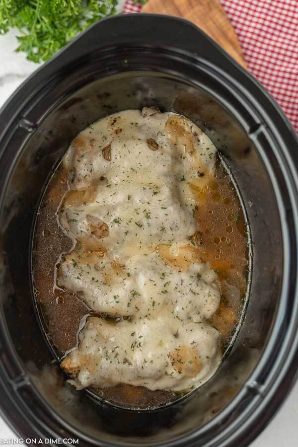 Close up image of french onion chicken in the crock pot. 